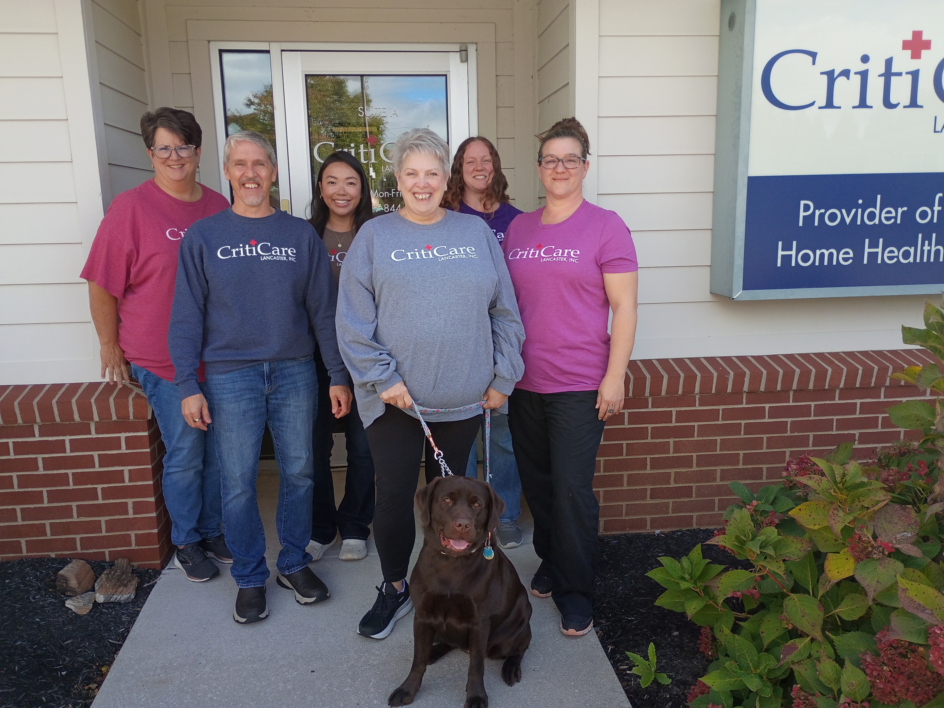 CritiCare Lancaster office team and Maple gathered outside headquarters